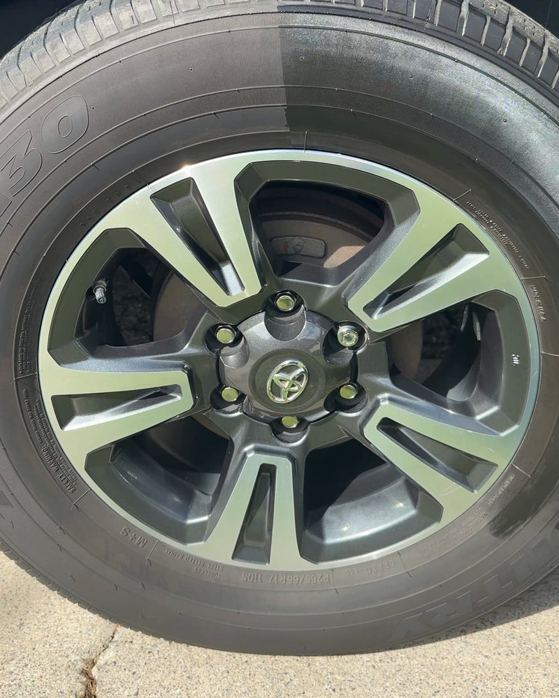 A Tacoma tire, the right half coated with Rubber Lock, the tape just pulled