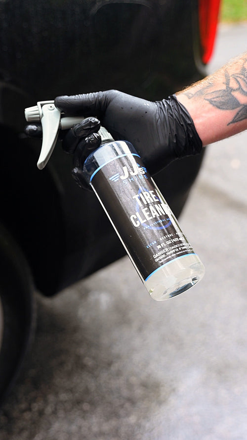 JJ's Tire & Wheel Cleaner held up at the wheel, its grey sprayer on