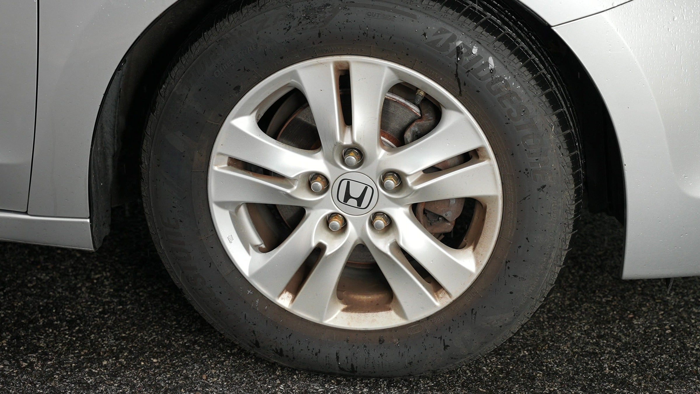 Dirty, grime-coated wheel and tire before treatment
