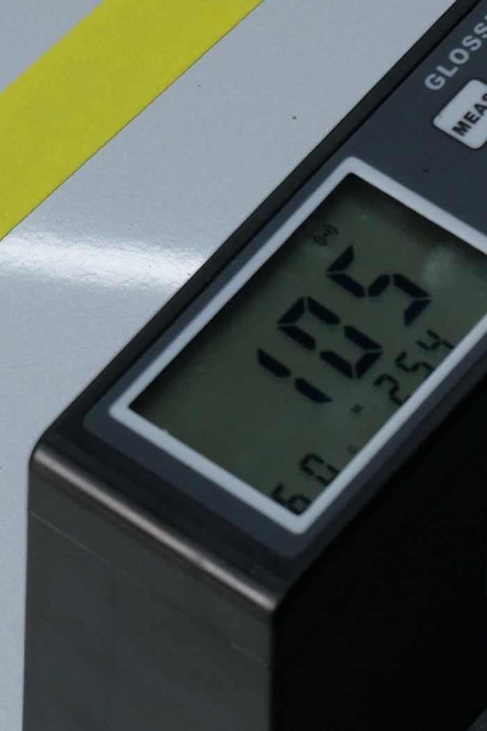 The same gloss meter after polishing with True Level, reading 105